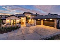 Stunning stone house with a three-car garage and well-manicured landscaping at 7952 Dante Dr, Littleton, CO 80125