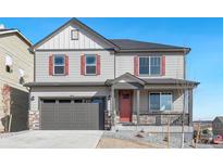 Two-story house with gray siding, red shutters, and a gray three-car garage at 18344 Prince Hill Cir, Parker, CO 80134