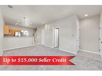 Bright, open-concept living room features plush carpeting and easy access to the modern kitchen at 1401 W 85Th Ave # F201, Federal Heights, CO 80260
