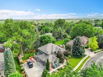 Stunning aerial view of a home with lush landscaping and mature trees in a desirable neighborhood at 1321 Ruby Way, Longmont, CO 80504