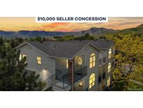Inviting condo boasts mountain views, seller concession, covered balconies, and steps to entry, nestled near trees at 1670 S Deframe St # C2, Lakewood, CO 80228