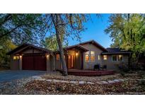 Charming home featuring a warm-toned exterior, inviting front porch, and landscaped front yard with mature trees at 2624 Kalmia Ave, Boulder, CO 80304