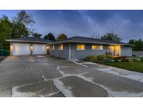 Charming home with a two-car garage and spacious cracked driveway at dusk at 1100 E Harvey St, Castle Rock, CO 80108