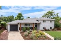 Charming two-story home with a well-maintained yard and a beautiful flower bed at 2075 Oakland St, Aurora, CO 80010