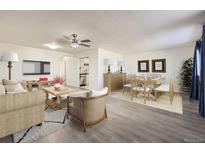 Bright living room featuring hardwood floors, neutral paint, and an open floor plan at 4940 E Donald Ave # 8, Denver, CO 80222