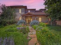 Charming home with lush landscaping and a stone pathway leading to the front porch at 3135 11Th St, Boulder, CO 80304