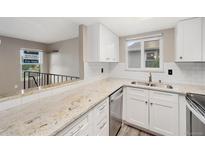 Bright kitchen features granite countertops, white cabinets and subway tile backsplash at 10001 E Evans Ave # D, Aurora, CO 80247