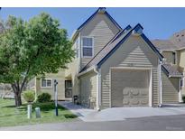 Inviting exterior with well-maintained lawn, attached garage, and mature shade tree at 10359 W Fair Ave # F, Littleton, CO 80127