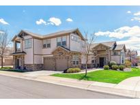 Beautiful two-story home featuring stone accents, a two-car garage, and well-manicured lawn at 23110 York Ave, Parker, CO 80138
