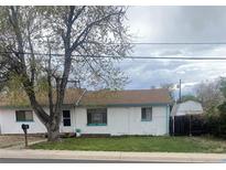 Charming single-story home with fresh white paint, a brown shingle roof, and a well-manicured lawn at 5515 Zuni St, Denver, CO 80221