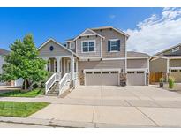 Charming two-story home with a three-car garage, landscaped yard, and inviting front porch at 15201 Yellowthroat St, Parker, CO 80134