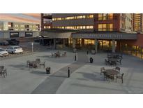 A modern building exterior with outdoor seating and parking, perfect for enjoying the city view at 100 Park W Ave # 1806, Denver, CO 80205