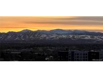 Breathtaking mountain view at sunrise with orange sky and snow-capped peaks, offering a serene backdrop at 300 W 11Th Ave # 10D, Denver, CO 80204