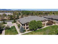Stunning aerial view of a two-story home with lush landscaping and mountain views on a sunny day at 11374 Xavier Dr # 202, Westminster, CO 80031