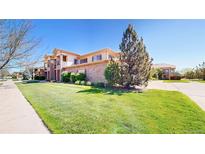 Beautiful two-story home featuring a stone facade and well-manicured lawn at 11374 Xavier Dr # 202, Westminster, CO 80031
