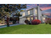 Charming home featuring a well-manicured lawn, mature tree, and attached two car garage at 1745 S Kline Way, Lakewood, CO 80232