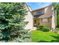 Charming home with lush green lawn, mature trees, and inviting entrance at 10369 E Red Mtn, Littleton, CO 80127