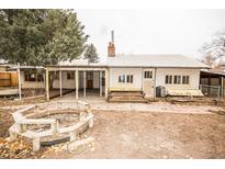 View of a house with a fire pit and patio in the backyard at 4263 S Elati St, Englewood, CO 80110