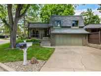Charming two-story home with attached two car garage and manicured lawn at 7238 W Cedar Cir, Lakewood, CO 80226