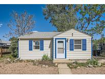 Charming bungalow-style home featuring crisp white siding, blue trim and accents, and a neatly maintained front yard at 5424 Saulsbury Ct, Arvada, CO 80002