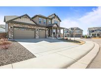 Beautiful two-story home featuring a wide driveway and meticulously maintained landscaping at 1624 Pinion Wing Cir, Castle Rock, CO 80108