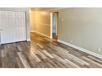 Bright living room boasts wood floors, white trim, and neutral paint for a modern, airy feel at 1390 Emerson St # 107, Denver, CO 80218