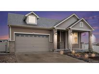 Inviting two-story home boasts a well-manicured lawn and an attached two-car garage at 5521 Ensenada St, Denver, CO 80249