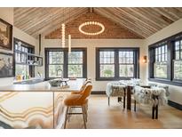 Modern kitchen with a marble island, exposed brick, high ceilings, and large windows at 3309 E 7Th Ave Pkwy, Denver, CO 80206