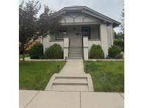 Charming painted brick bungalow with a landscaped front yard, walkway, and inviting front porch at 3743 N Yates St, Denver, CO 80212