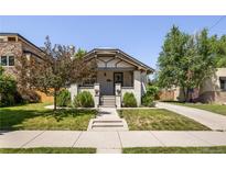 Charming bungalow with a well-manicured lawn and inviting curb appeal at 3743 N Yates St, Denver, CO 80212