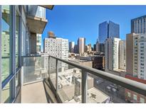 Enjoy breathtaking city views from this condo balcony with glass railings and sleek design at 891 14Th Street # 1712, Denver, CO 80202