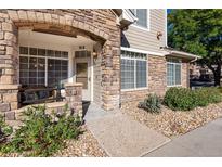 Charming front entrance featuring a stone archway and a cozy seating area at 12711 Colorado Blvd # 912, Thornton, CO 80241