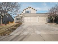 Charming two-story home featuring a three-car garage and well-maintained front yard at 1033 Quarterhorse Trl, Castle Rock, CO 80104