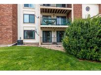 Backyard view of condo with patio, balcony and green space at 401 S Kalispell Way # 104, Aurora, CO 80017