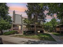 Multi-level home featuring a chimney and a small porch with natural landscaping at 5300 E Cherry Creek South Drive # 918, Denver, CO 80246
