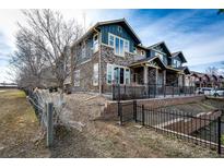 Charming stone and siding exterior with inviting porch and manicured landscaping at 604 S Norfolk Way, Aurora, CO 80017