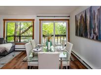 Bright dining area with glass table, seating for six, and views to the outside at 827 Maxwell Ave # H, Boulder, CO 80304