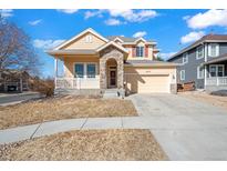 Charming two-story home with stone accents, covered porch, and attached two-car garage at 10209 Richfield St, Commerce City, CO 80022
