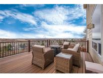 Enjoy the outdoor deck with wicker seating and gorgeous neighborhood views at 7360 Almandine Ct, Castle Rock, CO 80108