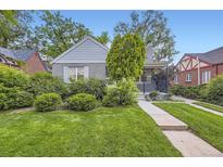 Charming home with lush green lawn, mature landscaping, and inviting front porch at 1640 Pontiac St, Denver, CO 80220