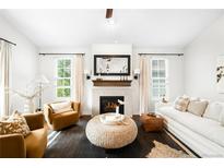 Bright living room features a cozy fireplace, neutral colors, and stylish furnishings at 3320 Yukon Ct, Wheat Ridge, CO 80033
