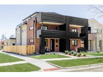 Stunning three-story home boasts sleek, modern architecture with a red brick facade and black metal accents at 2090 Eliot St, Denver, CO 80211