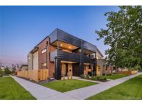 Modern two-story townhome features brick and dark metal exterior, landscaped yard, and inviting curb appeal at 2090 Eliot St, Denver, CO 80211