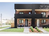 Striking brick townhome with black accents, a cozy front porch, and modern curb appeal at 2090 Eliot St, Denver, CO 80211