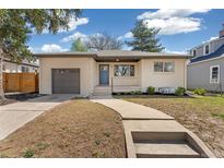 Charming single-story brick home with a well-maintained lawn, a walkway, and a one car garage at 4916 Knox Ct, Denver, CO 80221