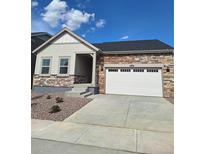 Charming single Gathering house with brick and siding details and an attached two car garage at 15286 Fillmore St, Thornton, CO 80602