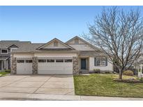 Charming single-Gathering home with a three-car garage, manicured lawn, and inviting curb appeal at 15870 Duckweed Ct, Parker, CO 80134