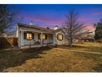 Charming one-story home with a cozy front porch and well-maintained yard at 725 Dahlia St, Denver, CO 80220