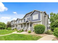 Inviting townhome exterior with manicured lawn, charming porch and attractive siding at 19216 E Idaho Pl # 102, Aurora, CO 80017