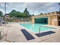 Outdoor pool area with lounge chairs, and well maintained landscaping with attached covered area at 7375 E Quincy Ave # 204, Denver, CO 80237